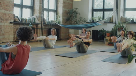 women exercising during group yoga class