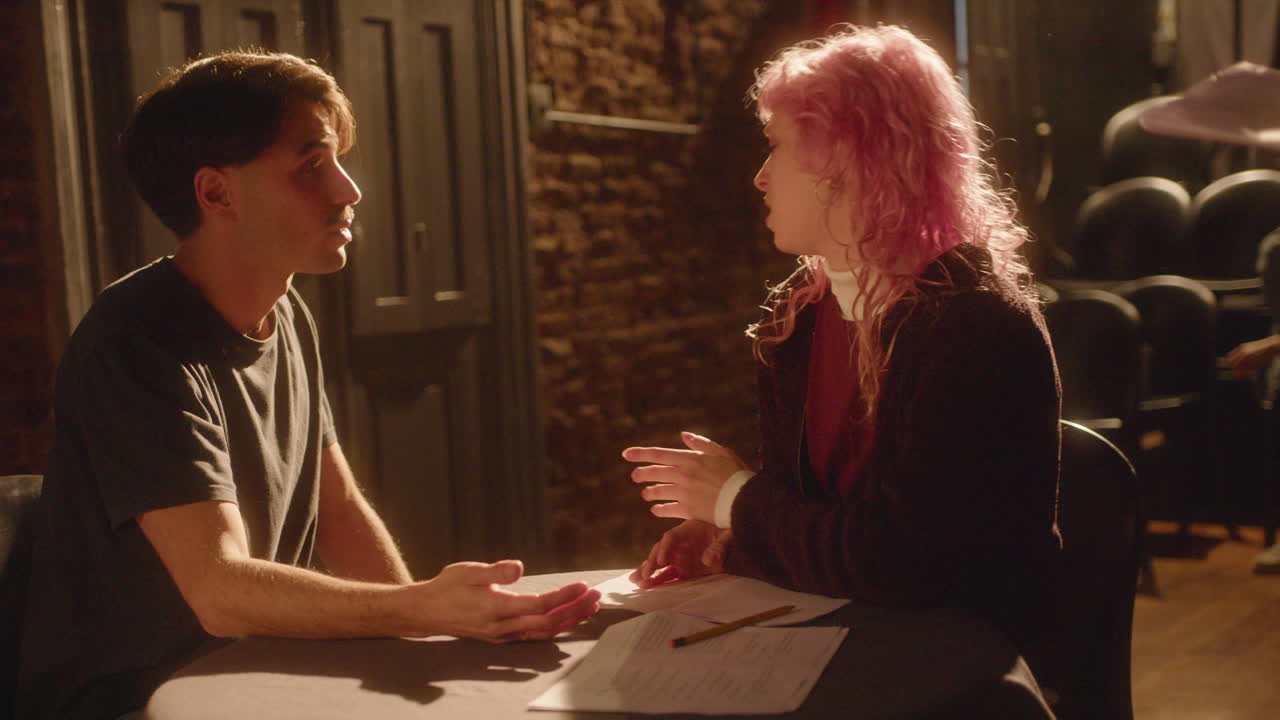 Stage Director Watching Actors Rehearsing Emotional Dialogue