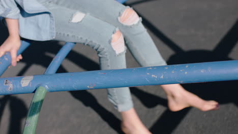 close-up-feet-woman-on-merry-go-round-spinning-legs-dangling-barefoot-enjoying-fun-on-summer-vacation-teenage-girl-barefoot-in-school-yard