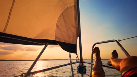 close up shot relaxed traveler man legs on motorboat on beautiful island and mountain carefree concept