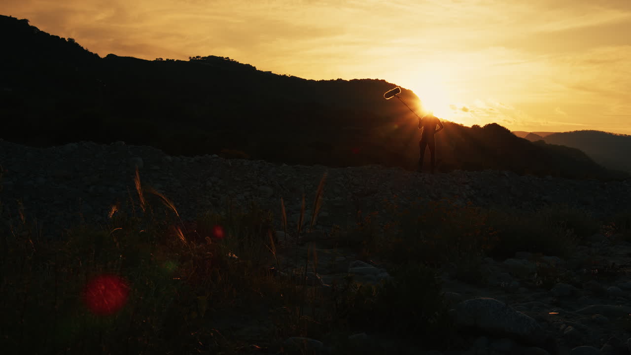 Silhouette Of Boom Operator Microphone Recording Sound In The Nature
