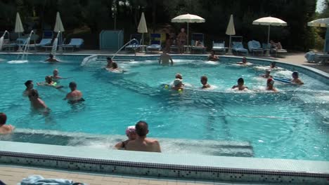 people relaxing in a resort pool
