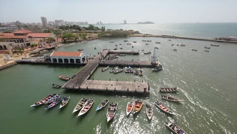 aerial orbital, traditional wooden boats, maritime lifestyles, city pier