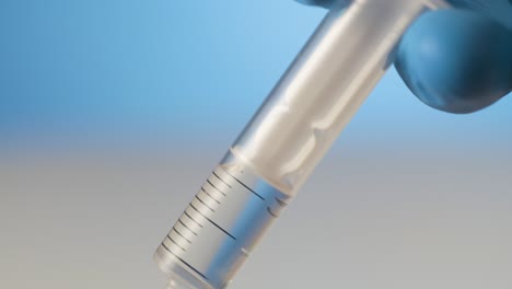 extreme close-up liquid in syringe injection needle, concept getting a shot