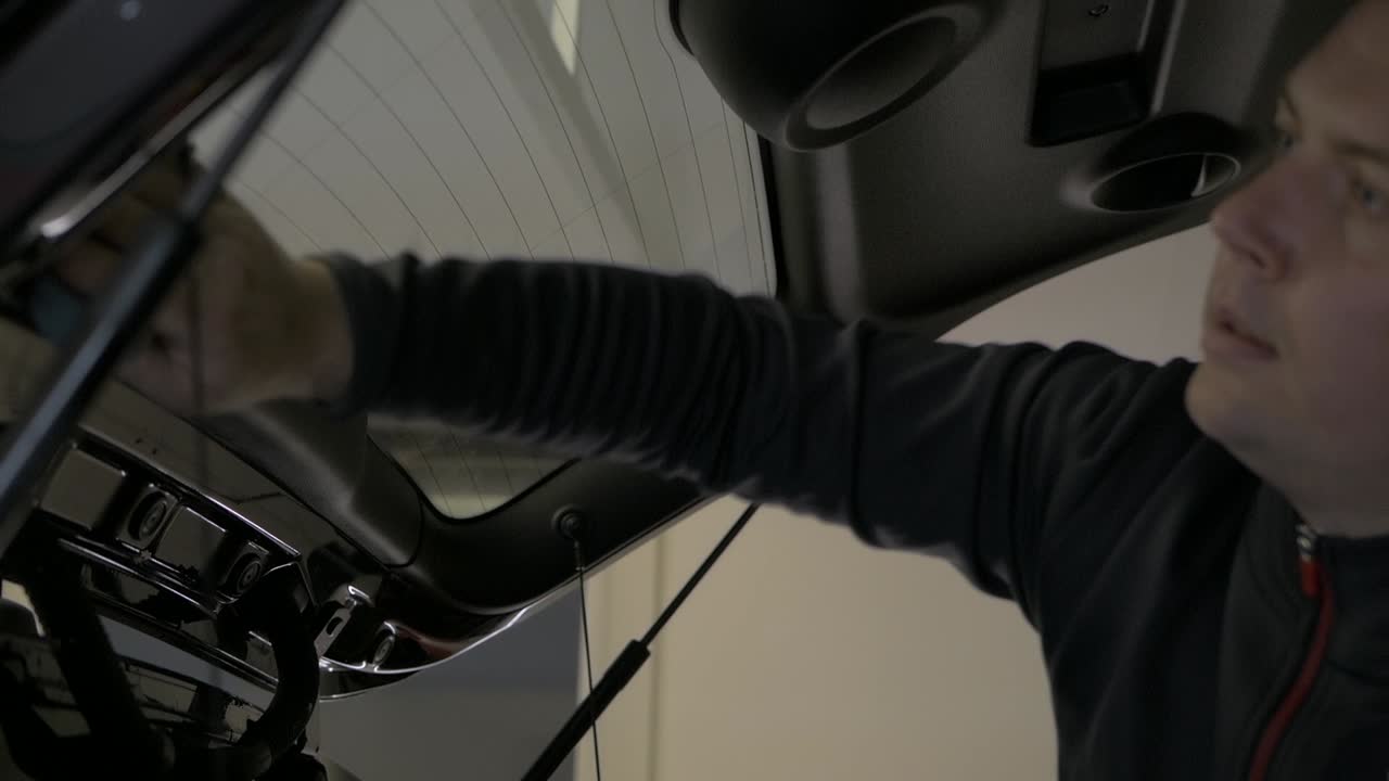 Car boot rear window being cleaned getting ready for window tinting. Window tint