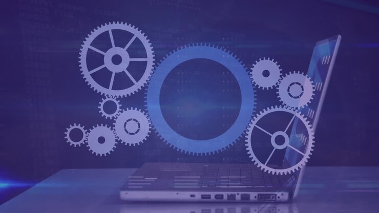 Animation of cogs moving over businessman using laptop