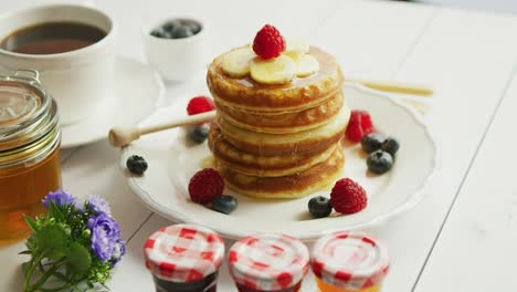 pancakes with slices of banana and berries