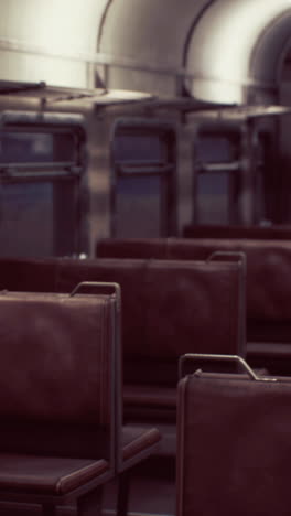 interior of a vintage train with red leather seats