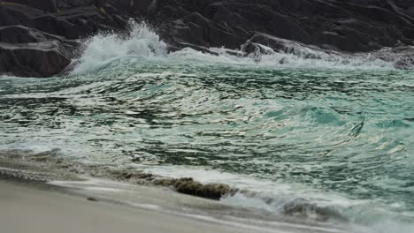 strong waves are crashing on the rocky shore