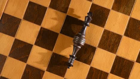 beaten from war, chess pieces king and queen laying down on chessboard