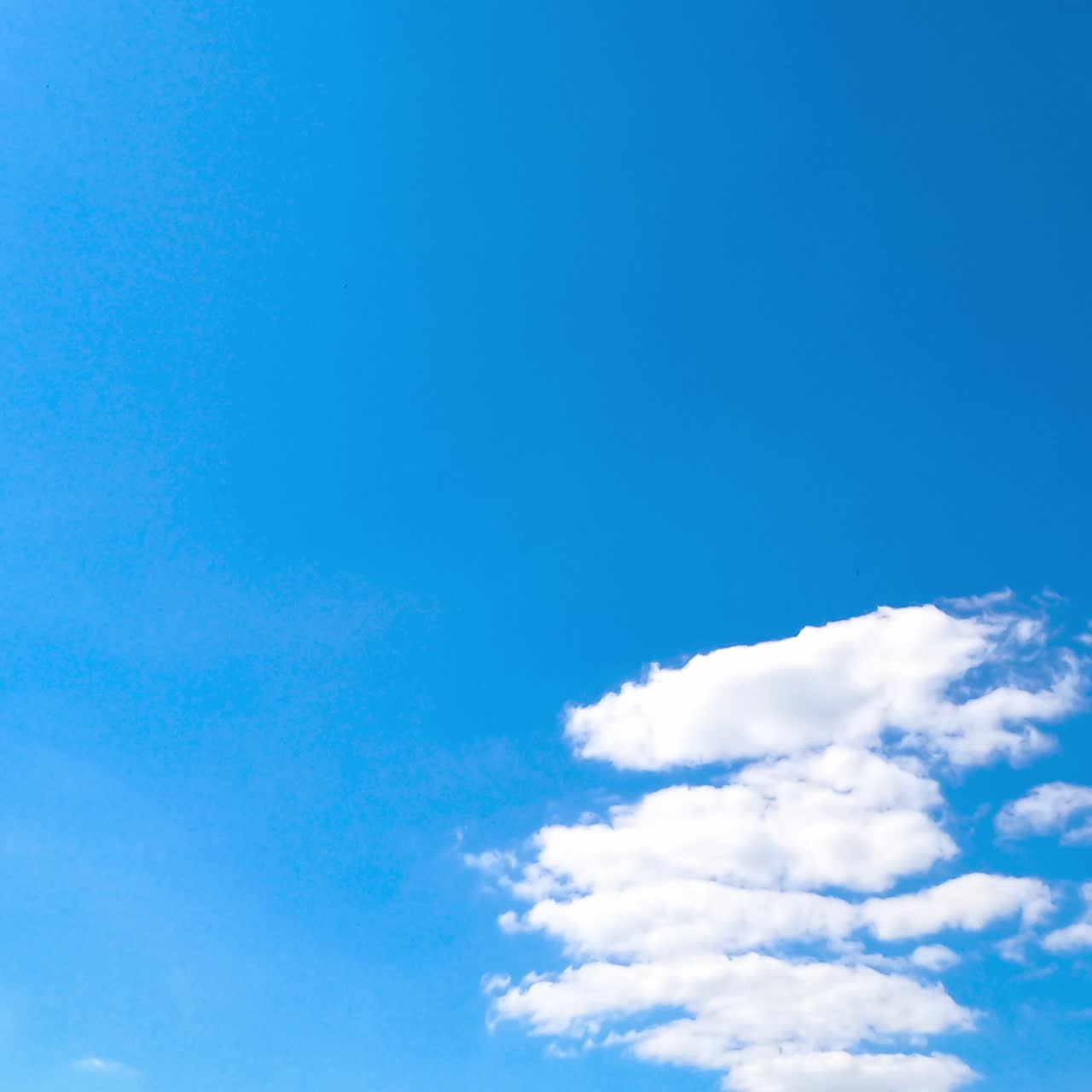 Light blue sky with appearing clouds. Transforming cloudscape timelapse on sunny day