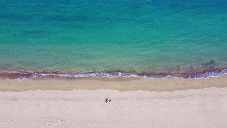 Top-view-of-beautiful-beach-with-one-person-on-it