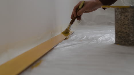 painting baseboards with gold paint - diy home improvement project
