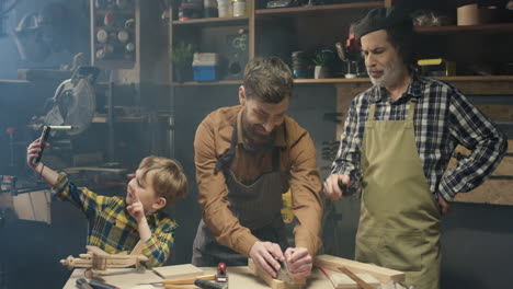 Happy-Caucasian-family-of-carpinters-in-workshop