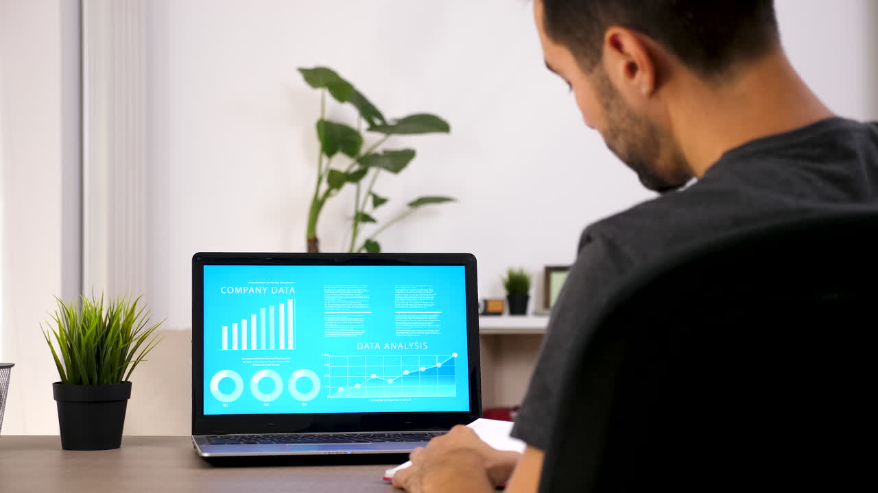 Man working on data analysis with laptop