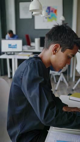 student working on a laptop in a modern workspace