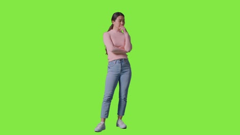 full length studio portrait of woman turning to look all around frame against green screen 1