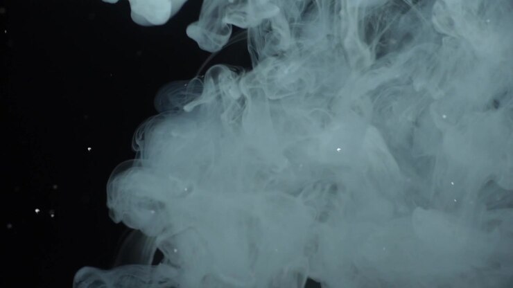 Fumo e particelle su sfondo nero.