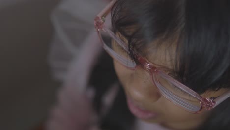 close-up of a girl wearing pink glasses