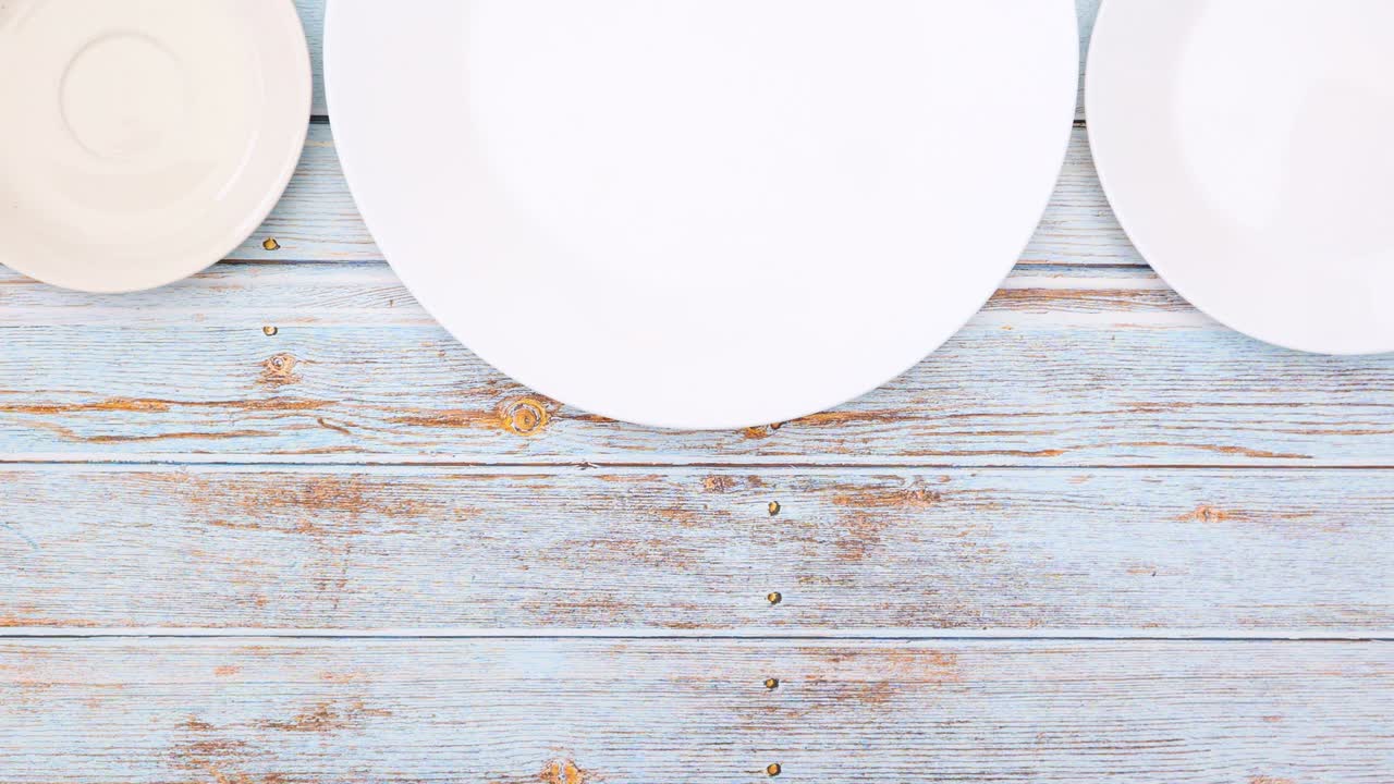 Different shapes of chocolates appear in white plates - Stop motion