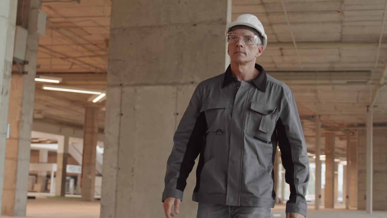 Confident Builder Putting on Goggles Walking