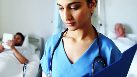 Portrait-of-female-doctor-holding-medical-report