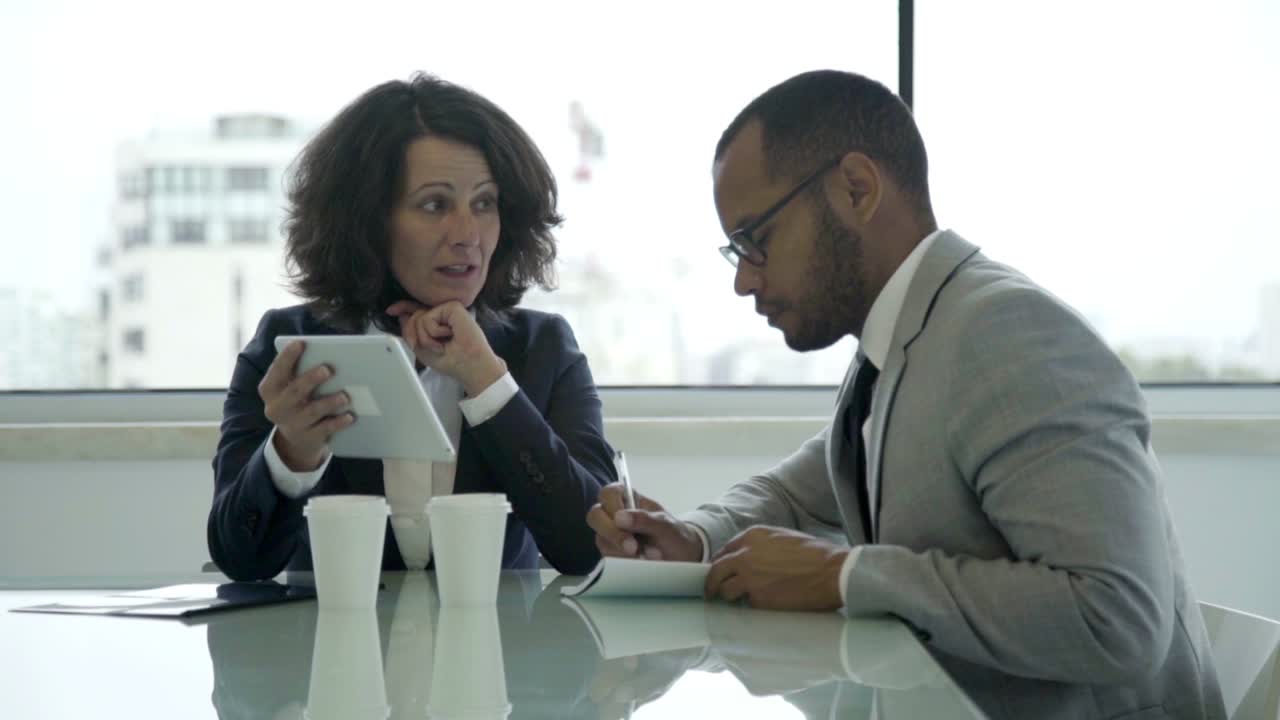 Cheerful business companions discussing business issues