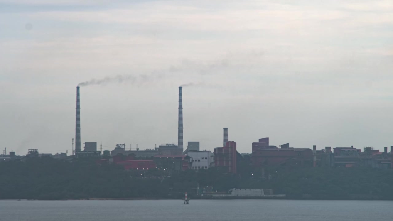 Time lapse of industrial pollution releasing polluting fumes into the air