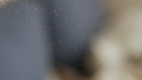 Dust particles float in the air indoors, close up