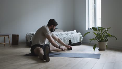 man stretching at home