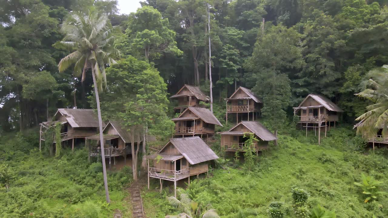 vista aérea del grupo de antiguas cabañas de madera abandonadas en la selva tropical.