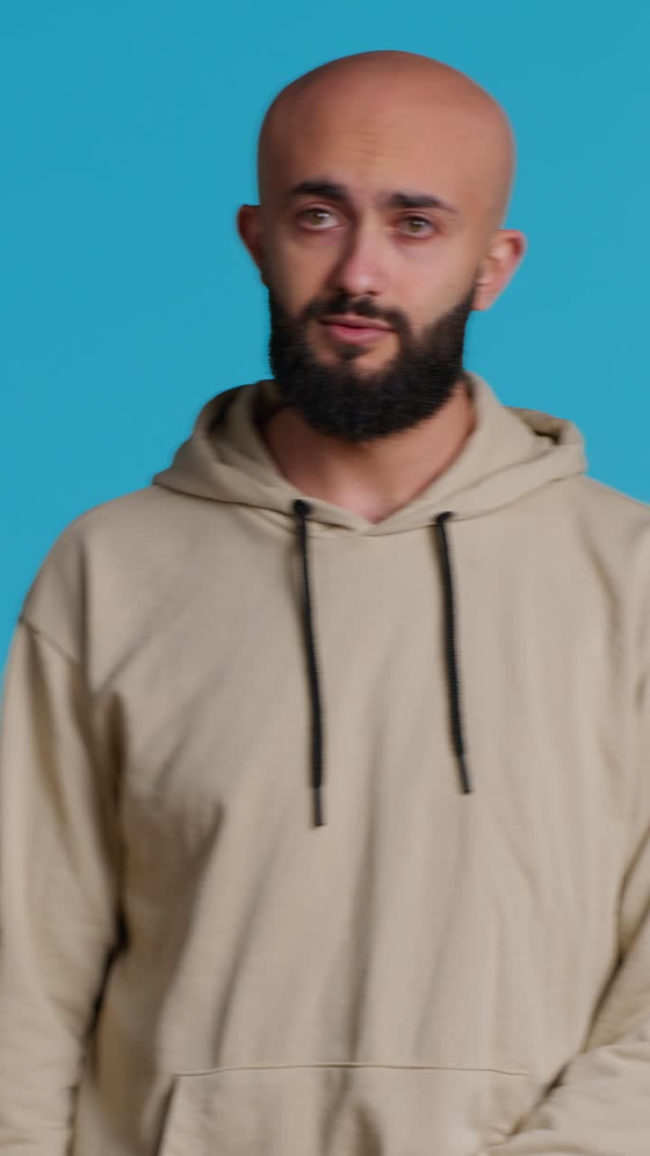 Vertical Video Young adult gesturing no over blue background