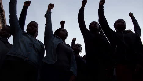 people raising fists in protest and solidarity