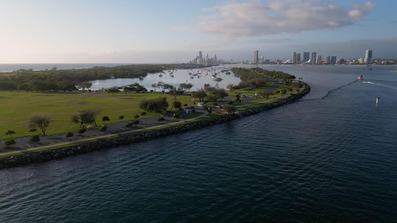 Right to left aerial views over The Spit and seaway on the northern end of the Gold Coast in the morning on a sunny day.