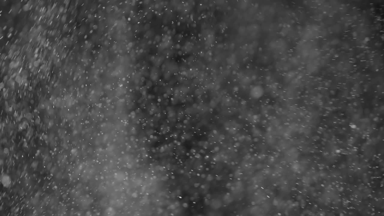 초 검은색 배경에 눈 입자가 여 있습니다.