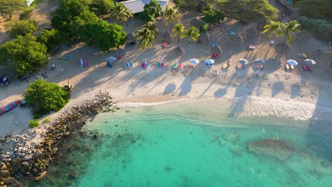 high angle overview of whitewash waves crashing on luxurious tropical caribbean paradise shoreline