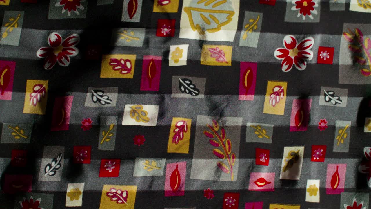 Leaf pattern silk fabric flowing / blows in the wind in slow motion / background texture