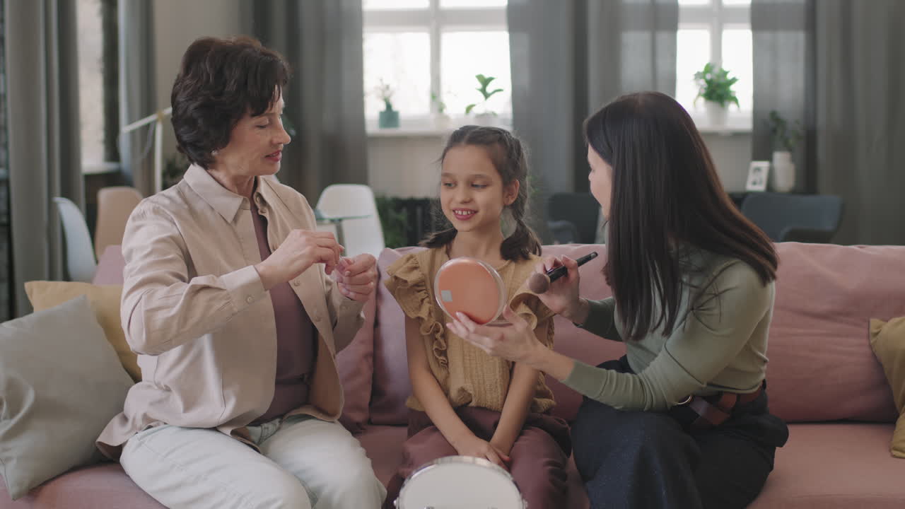 Family applying makeup together on the couch