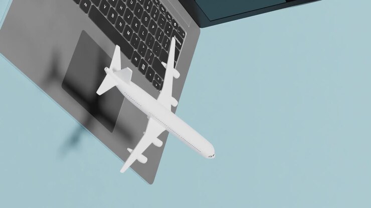 aeroplano che sorvola il computer portatile su sfondo blu con spazio di copia
