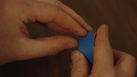 unrolling a segment of blue electric tape