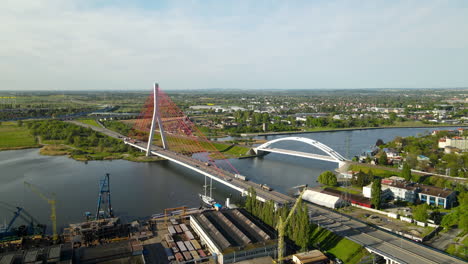 aerial view third millennium john paul ii bridge which links the northern port of gdansk with the national road network, port cargo terminal in foreground, and railway bridge over martwa wisla river