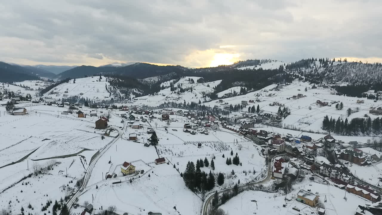 Snow-covered cottages in a ski resort. Olympic village. Aerial view