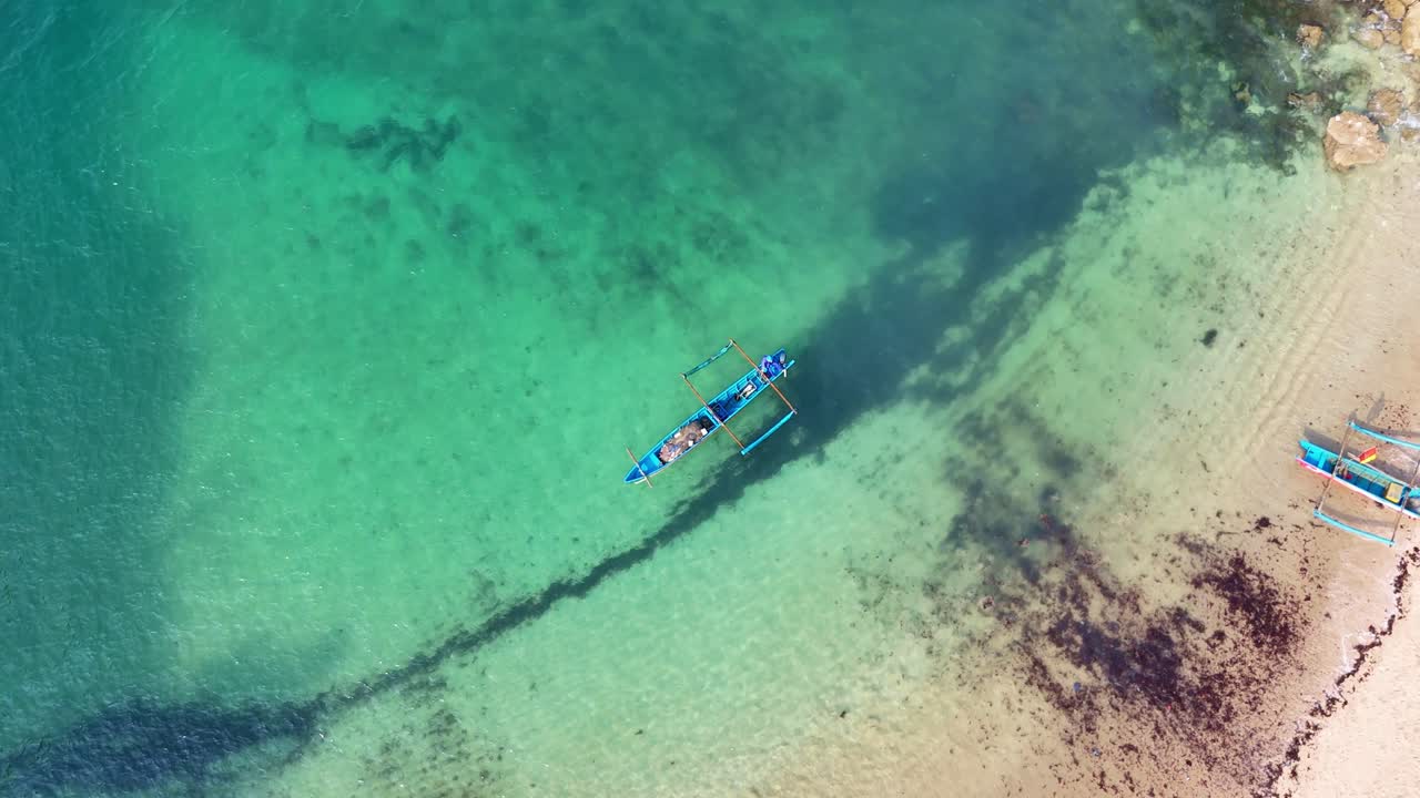 Aerial View of a Traditional Boat in Turquoise Water