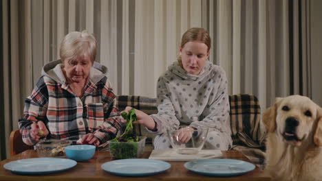 grandmother and granddaughter enjoying dinner together