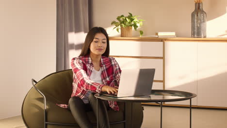 woman working on laptop in a cozy home office