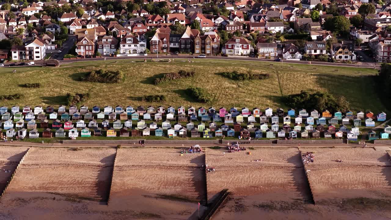Aerial view of Whitstable Beach with huts and town, sunny calm mood