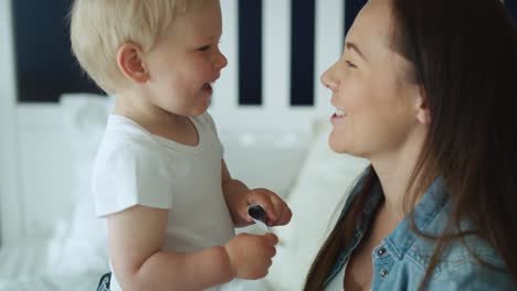 Close-up-video-of-playful-toddler-and-his-mother-.