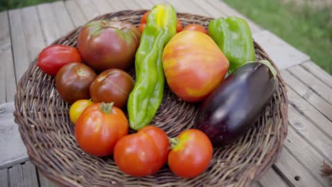 slow establishing shot of freshly selected vegetables sitting in a wooden basket