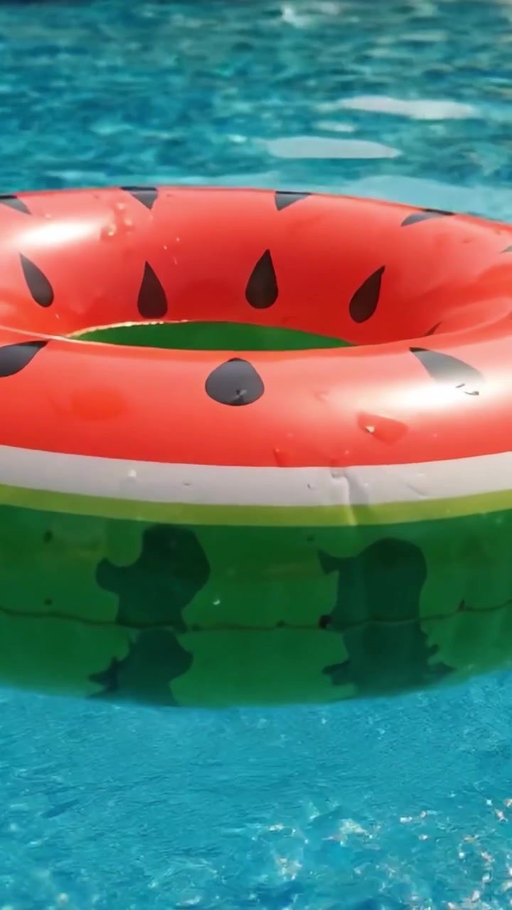 A Bright and Colorful Watermelon-Style Inflatable Floatie Perfect for Summer Pool Fun and Relaxation in a Clear Blue Swimming Pool Setting
