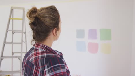 portrait of a caucasian woman in quarantine during coronavirus pandemic, doing interior work